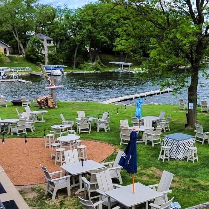 Highwater Bar back yard with fire pit, chairs and mroe